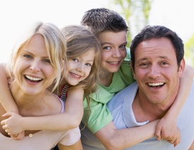 Smiling family of four outdoors