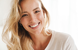 Closeup of woman with blonde hair smiling at home