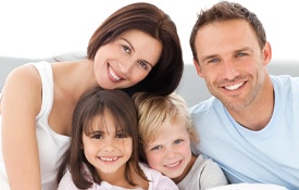 A family smiling for a photo.