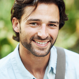 man in button down smiling