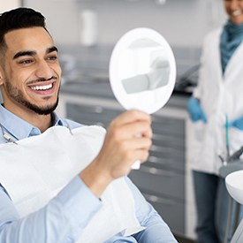 Patient smiling at reflection in mirror