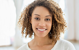 woman in white shirt smiling