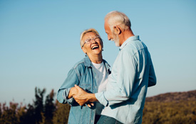 Couple smiling in hilltop outside