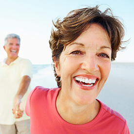 woman holding husbands hand smiling