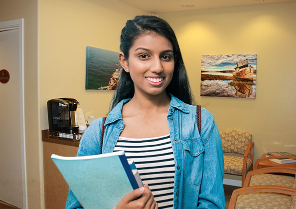 teenage girl smiling in waiting room