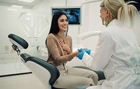 Smiling patient shaking dentist's hand