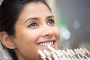 Smiling woman getting porcelain veneers in Petaluma