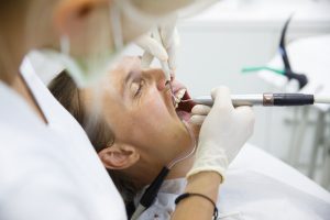 dentist performing root canal surgery