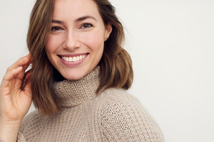 Woman in sweater smiling during the winter