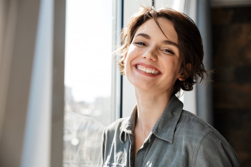 A woman smiling with her new dental veneers