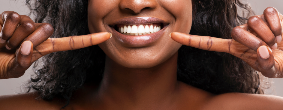 Woman pointing at white teeth