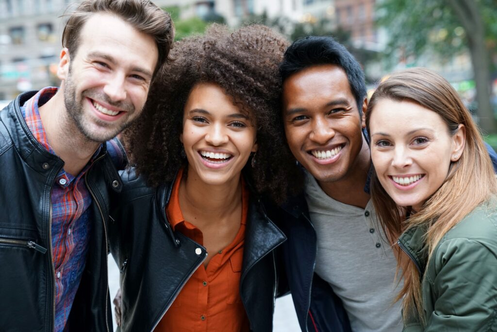 Four young adults outside smiling